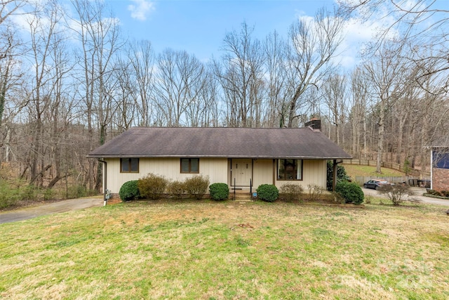 single story home with a chimney and a front lawn