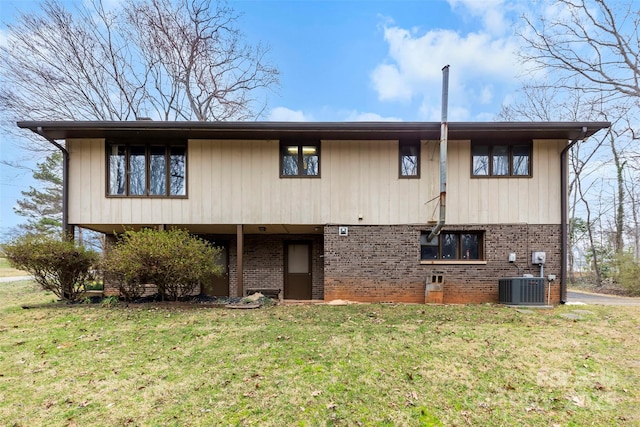 exterior space featuring a carport, a yard, brick siding, and central air condition unit