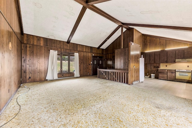 unfurnished living room with carpet floors, wood walls, high vaulted ceiling, and beam ceiling