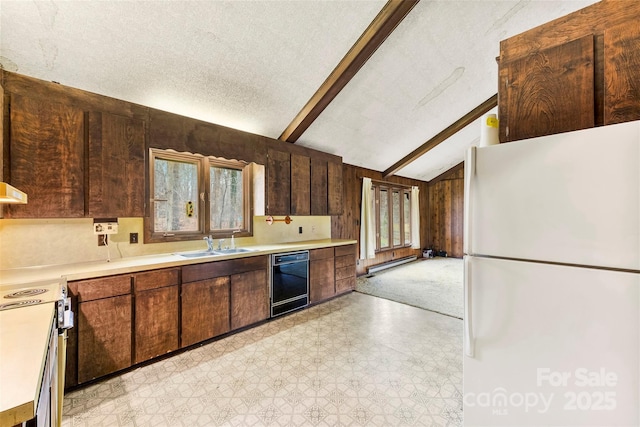 kitchen featuring light floors, black dishwasher, range with electric stovetop, and freestanding refrigerator