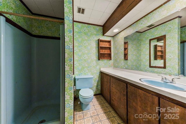 bathroom featuring toilet, vanity, visible vents, a stall shower, and wallpapered walls