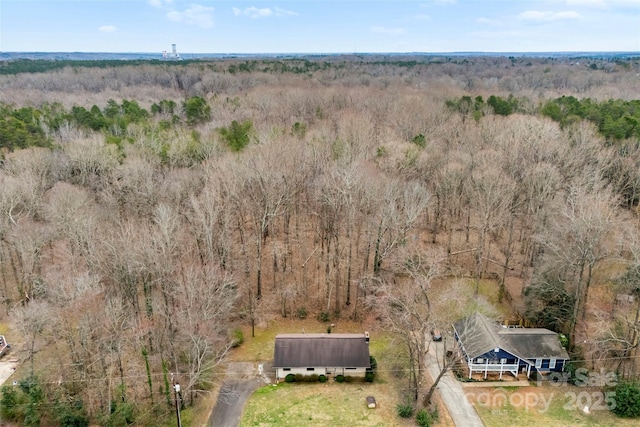 drone / aerial view featuring a forest view