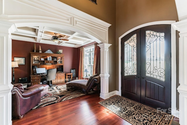 entrance foyer featuring ornate columns, arched walkways, hardwood / wood-style flooring, and french doors