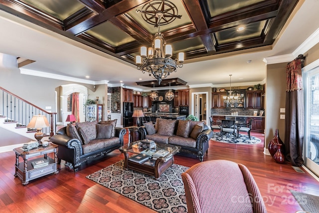 living area featuring crown molding, dark wood-style flooring, coffered ceiling, and a notable chandelier