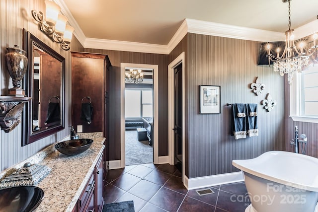 bathroom with a chandelier, a sink, and a wealth of natural light