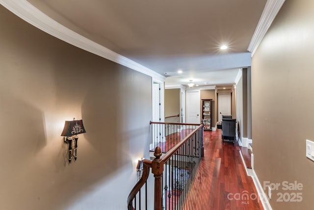 corridor featuring baseboards, dark wood finished floors, crown molding, an upstairs landing, and recessed lighting