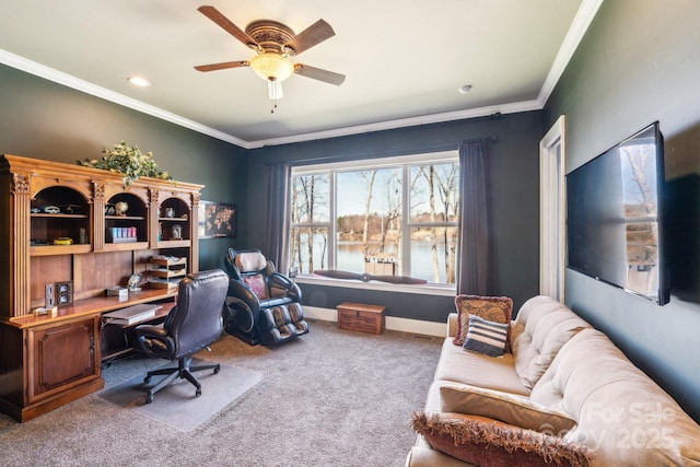 carpeted office space featuring ornamental molding, a ceiling fan, and baseboards