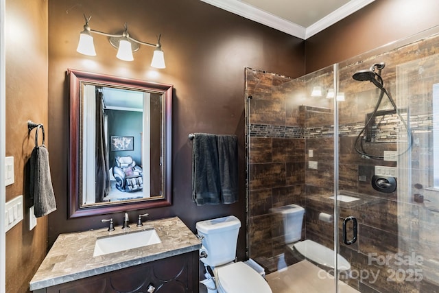 bathroom featuring toilet, a shower stall, ornamental molding, and vanity