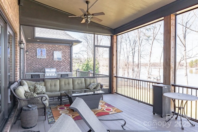 sunroom featuring lofted ceiling and ceiling fan