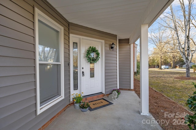 view of exterior entry with covered porch