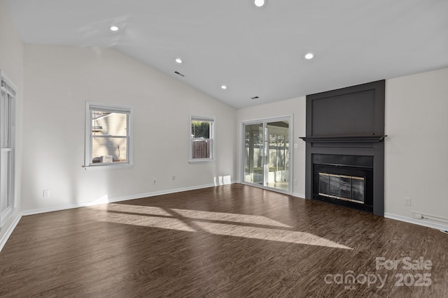 unfurnished living room featuring recessed lighting, a large fireplace, wood finished floors, baseboards, and vaulted ceiling