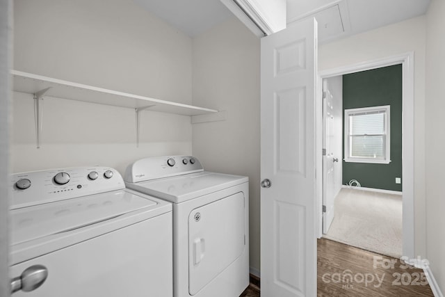 laundry area with dark wood-style floors, washing machine and clothes dryer, attic access, laundry area, and baseboards