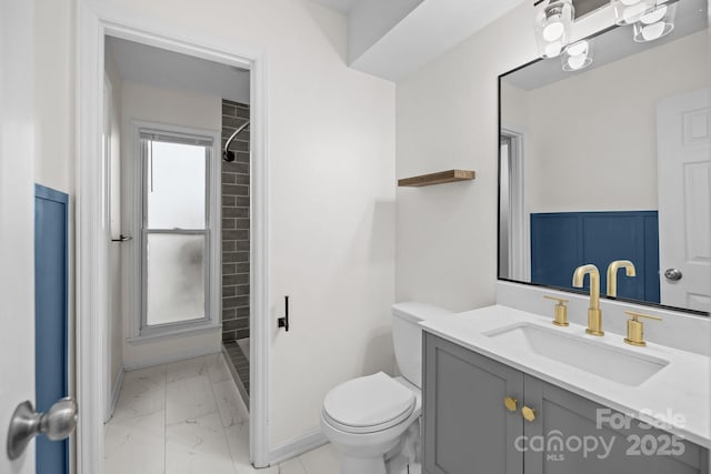 bathroom with baseboards, toilet, marble finish floor, vanity, and a shower stall