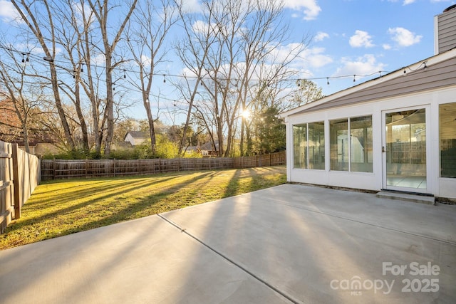 view of patio featuring a fenced backyard and a sunroom