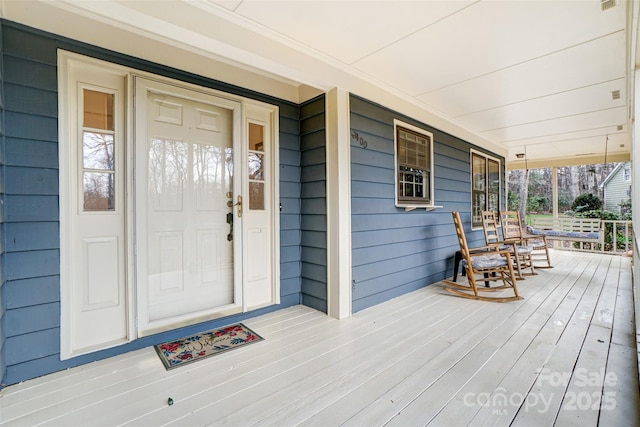 wooden terrace with a porch