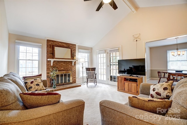 living area with a brick fireplace, plenty of natural light, beam ceiling, and light colored carpet