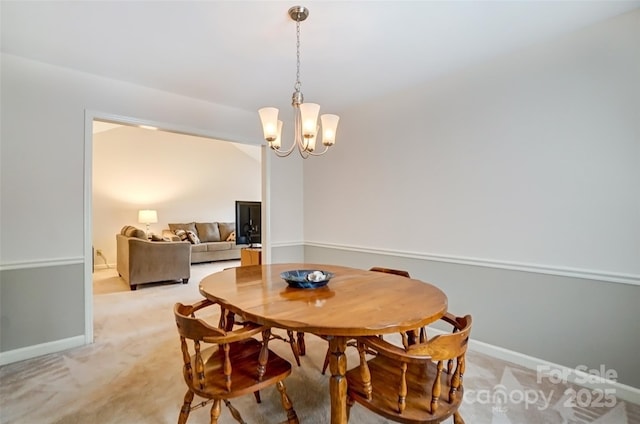 dining area featuring light carpet, an inviting chandelier, and baseboards