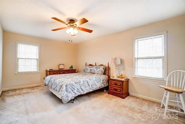 bedroom featuring multiple windows, carpet, and baseboards