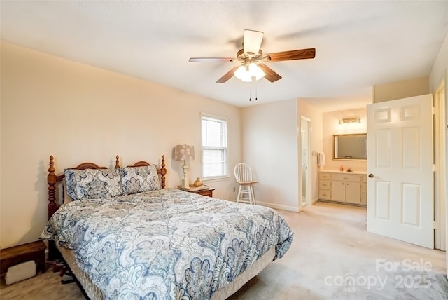 bedroom featuring baseboards, ensuite bath, a ceiling fan, and light colored carpet