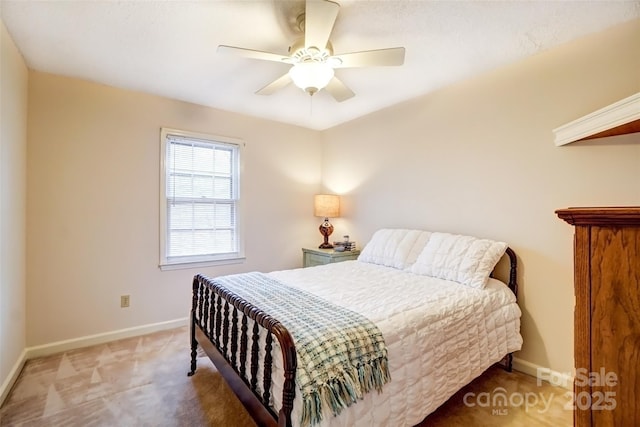 bedroom with ceiling fan, baseboards, and carpet flooring