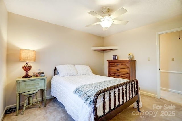 bedroom featuring light carpet, ceiling fan, baseboards, and attic access