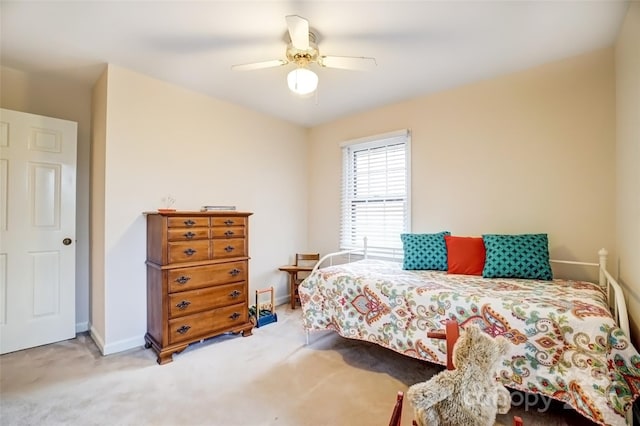 bedroom with a ceiling fan, baseboards, and carpet flooring