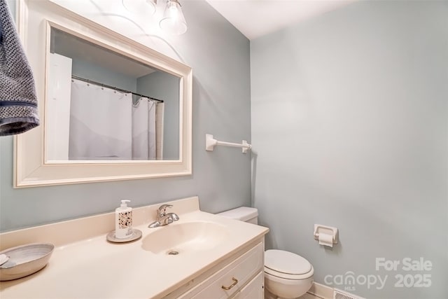 full bathroom featuring vanity and toilet