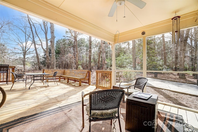 sunroom / solarium featuring ceiling fan