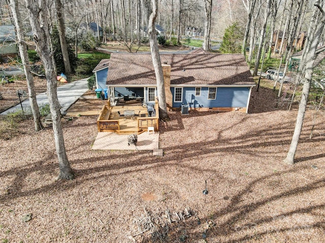 back of house featuring a wooden deck