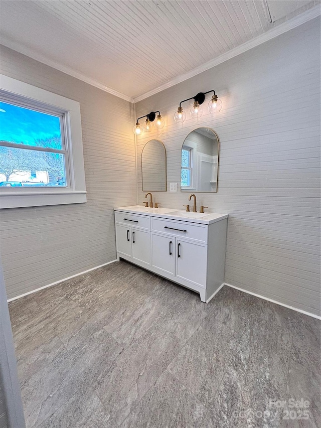 full bath featuring double vanity, a sink, and crown molding