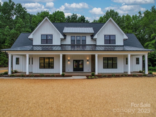 modern farmhouse with board and batten siding and a standing seam roof