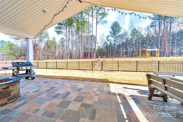 view of patio with grilling area and fence