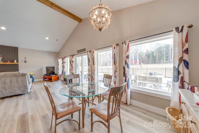 dining space with beamed ceiling, plenty of natural light, light wood-style flooring, and baseboards