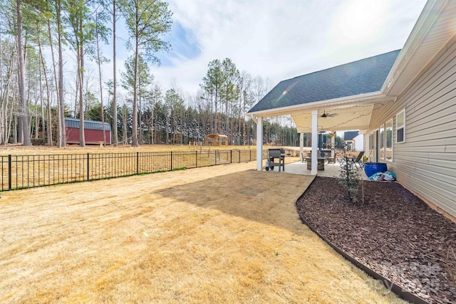 view of yard featuring a patio area, fence, and a ceiling fan