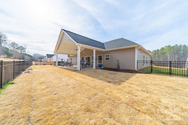 back of property featuring a fenced backyard and a patio