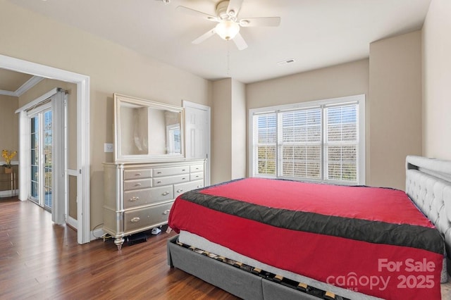 bedroom with multiple windows, ceiling fan, visible vents, and wood finished floors