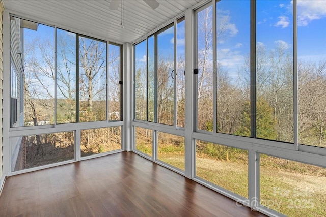 unfurnished sunroom featuring ceiling fan
