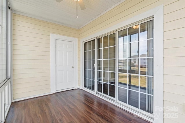unfurnished sunroom with ceiling fan