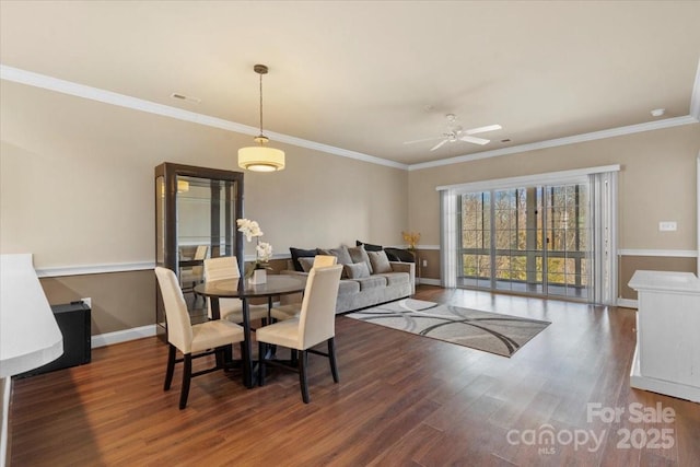 dining area with ceiling fan, ornamental molding, wood finished floors, and baseboards