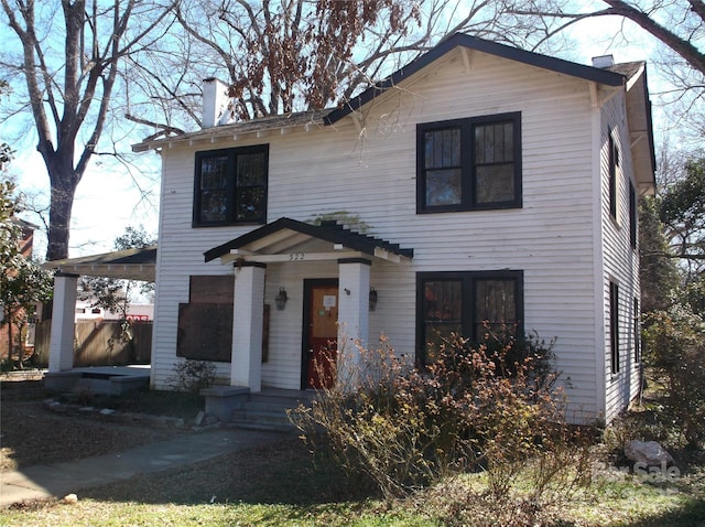 view of front of house featuring a chimney