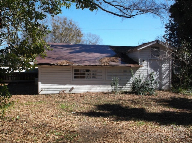 rear view of house featuring fence