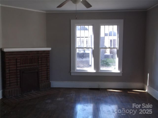 unfurnished living room featuring plenty of natural light, wood finished floors, and crown molding