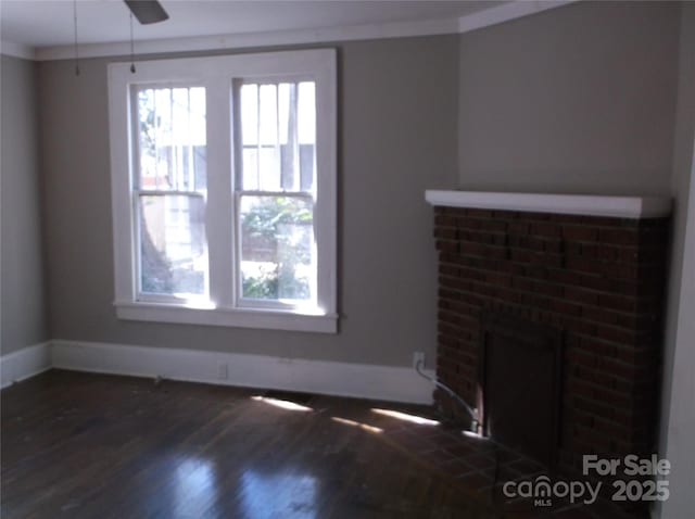 unfurnished living room featuring crown molding, a fireplace, wood finished floors, and a healthy amount of sunlight