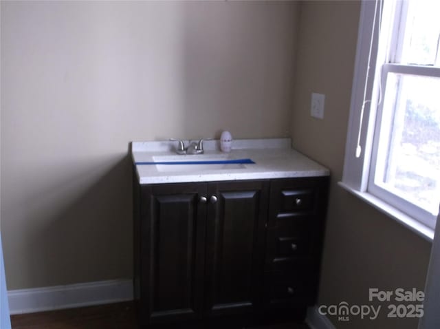 bathroom featuring baseboards and vanity