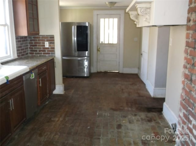 kitchen featuring glass insert cabinets, plenty of natural light, appliances with stainless steel finishes, and light countertops