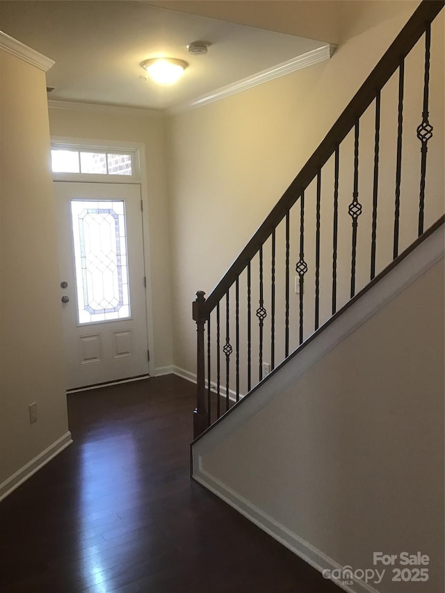 entryway featuring stairway, wood finished floors, baseboards, and ornamental molding