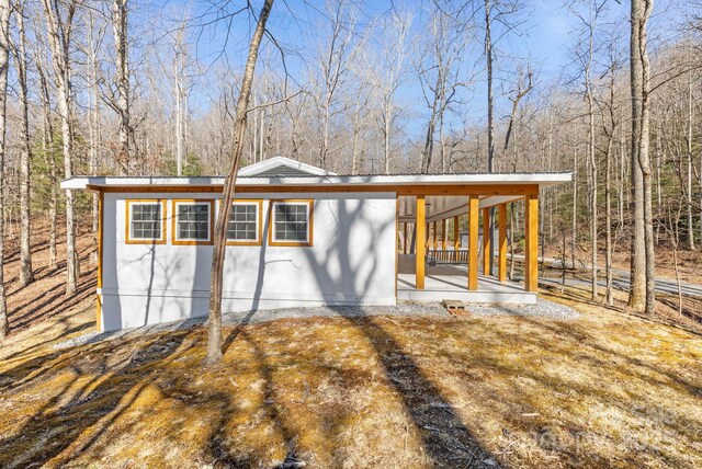 view of outbuilding with a view of trees