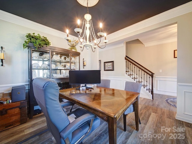 office with a wainscoted wall, ornamental molding, wood finished floors, a chandelier, and a decorative wall