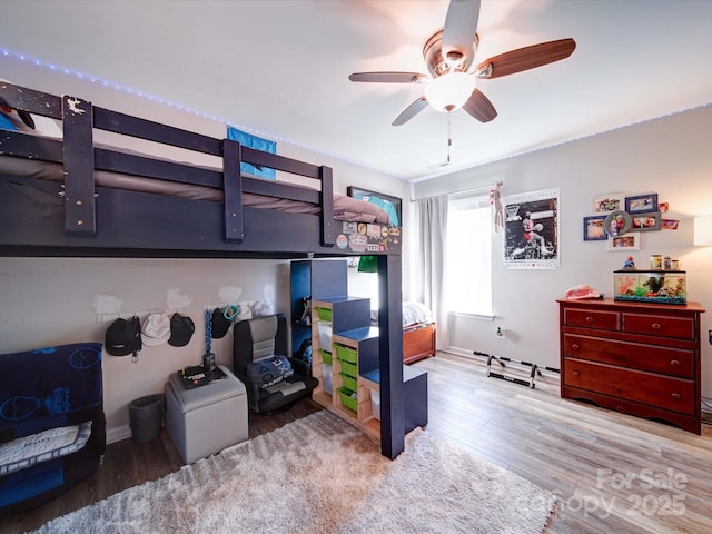 bedroom featuring wood finished floors and a ceiling fan