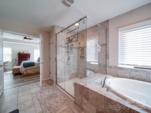 ensuite bathroom featuring a garden tub, a stall shower, plenty of natural light, and connected bathroom